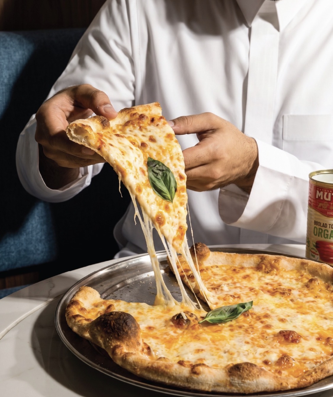 A guest lifting a slice of freshly baked margherita pizza at KRISP